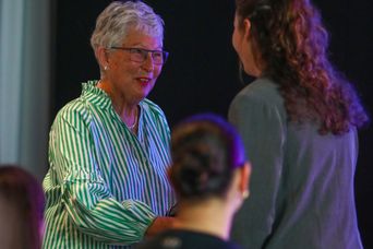 Sheryl, Lady Wells presents caps to scholars and alumni